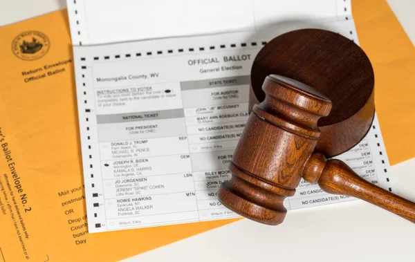 Gavel on top of absentee ballot to illustrate the court involvement in presidential election — Stock Photo, Image