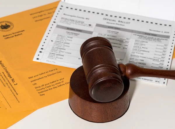 Gavel on top of absentee ballot to illustrate the court involvement in presidential election — Stock Photo, Image