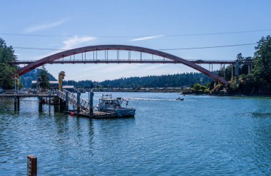 La Conner, WA - 23 August 2025: Boats docked alongside the waterfront of the small town of La Conner on Swinomish Channel by Rianbow Bridge