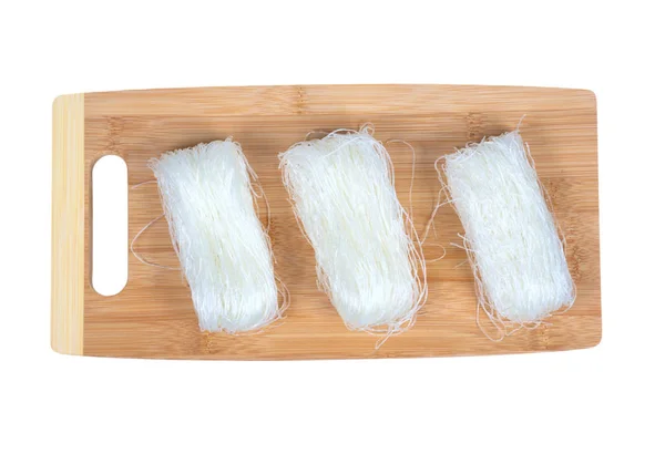 Dry bean noodles on a cutting board isolated on white. — Stock Photo, Image