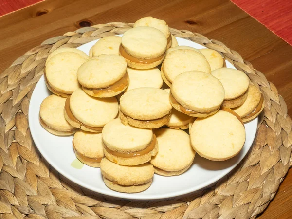 Traditional alfajores in Argentina, Peru, and Uruguay consist of two round, sweet biscuits made of wheat flour or corn starch joined together with dulce de leche