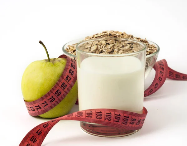 Green Apple, Kefir and Oatmeal with Measuring tape on white background — Stock Image Green Apple, Kefir and Oatmeal with Measuring tape on white background Stock Image