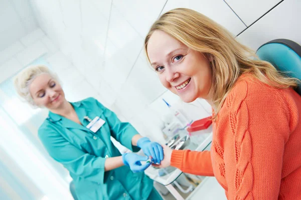 Blood test with disposable lancelet. nurse and woman at clinic — Stock Photo, Image