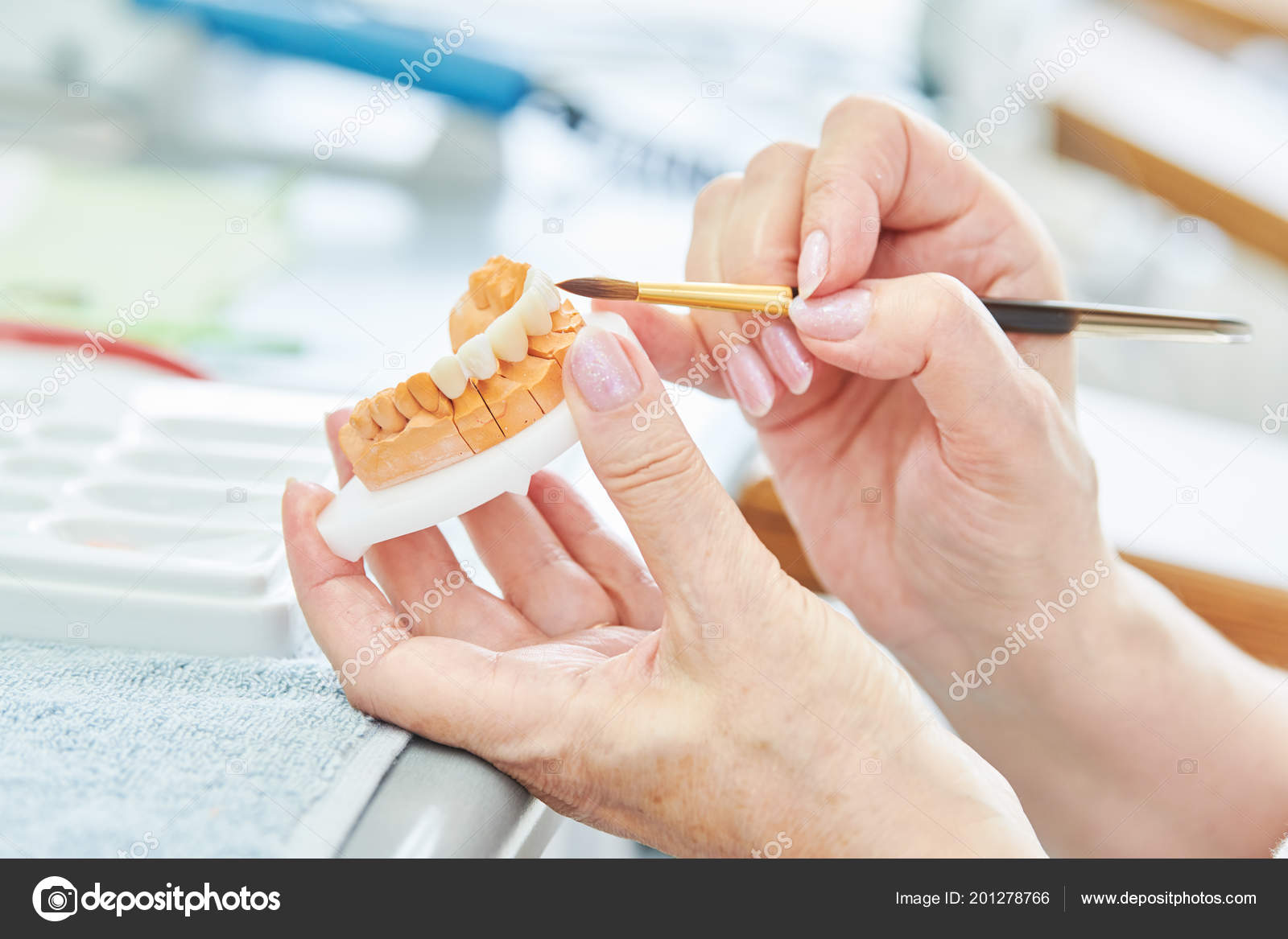 Dental technician work. prosthesis production. Painting teeth Stock