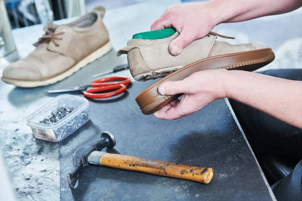 Shoemaker repair shoe. Glueing the sole for male footwear — Stock Photo, Image