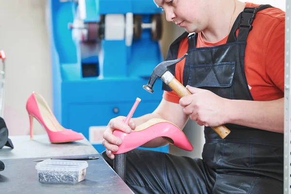 Shoemaker repair female spike shoe. Hammering tip on heel — Stock Photo, Image