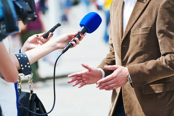 Media verslaggever met microfoon waardoor journalist interview voor nieuws — Stockfoto
