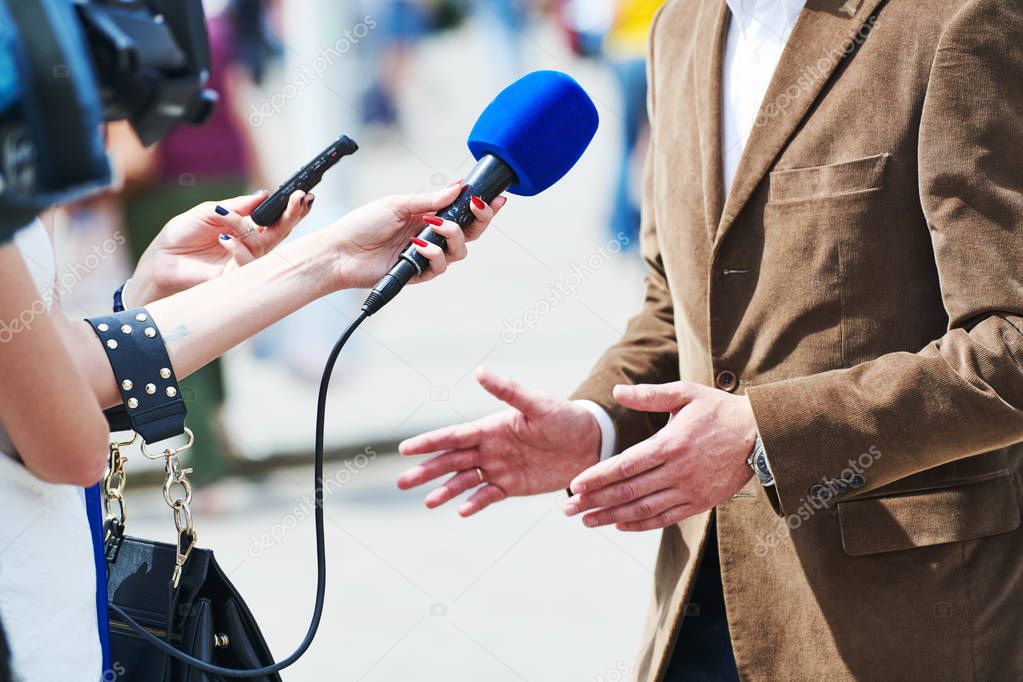 media reporter with microphone making journalist interview for news