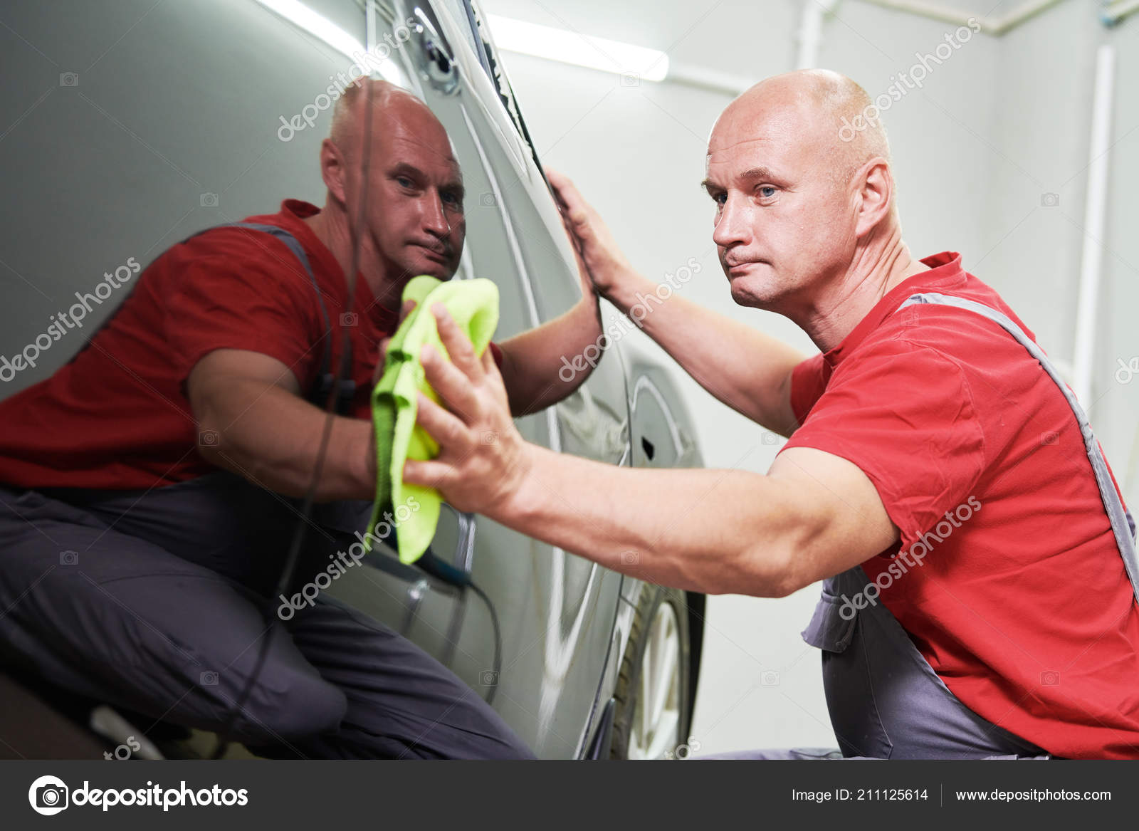 Repair Man Worker Polishing Automobile Car Body In Garage Stock