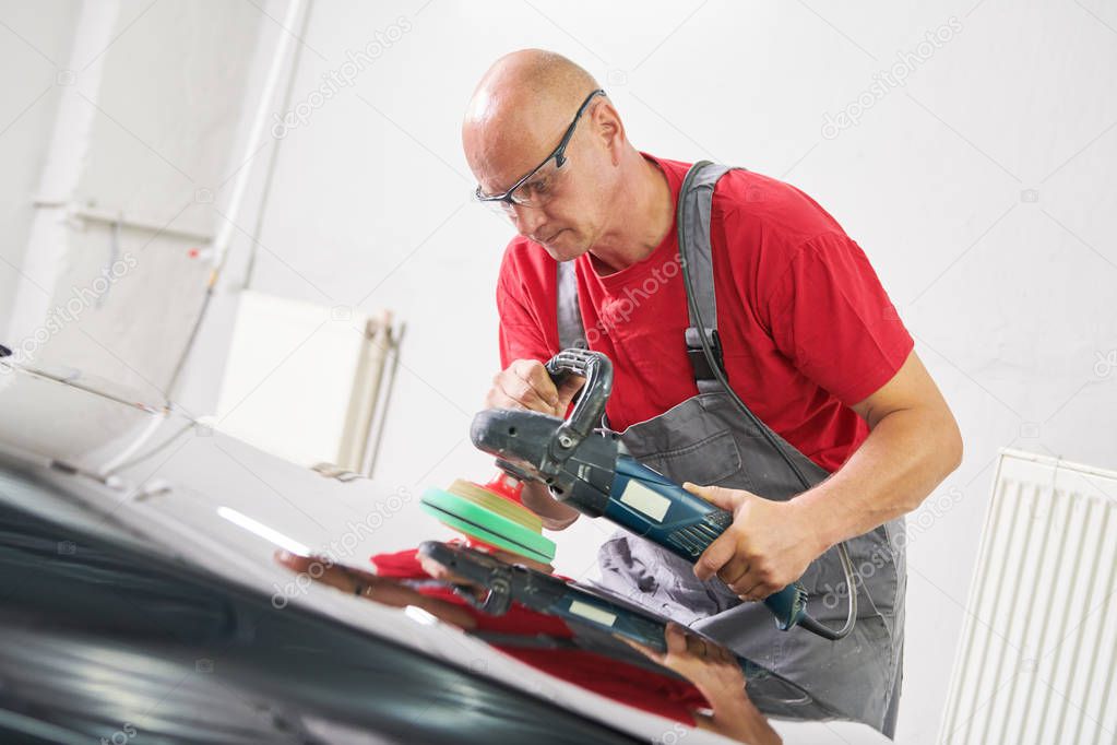 auto mechanic buffing car autobody