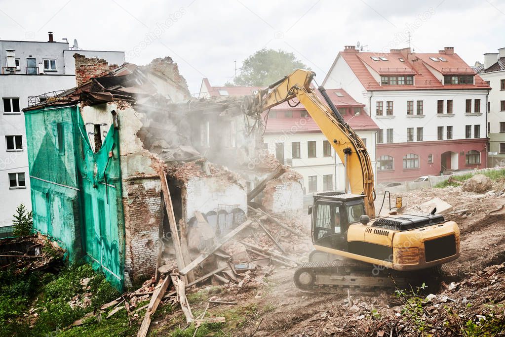 excavator crasher machine at demolition on construction site