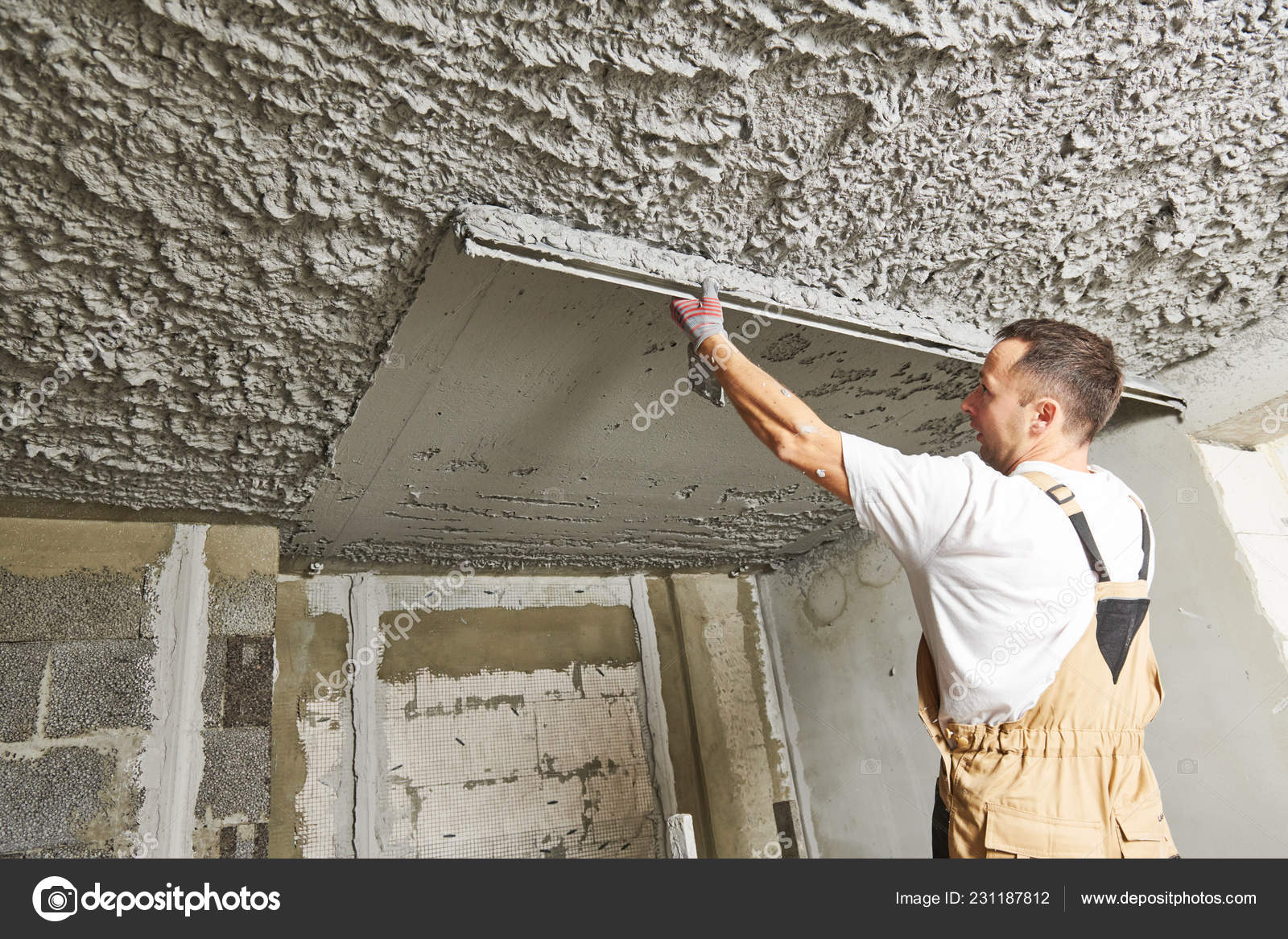 Plasterer Smoothing Plaster Mortar On Ceiling With Screeder