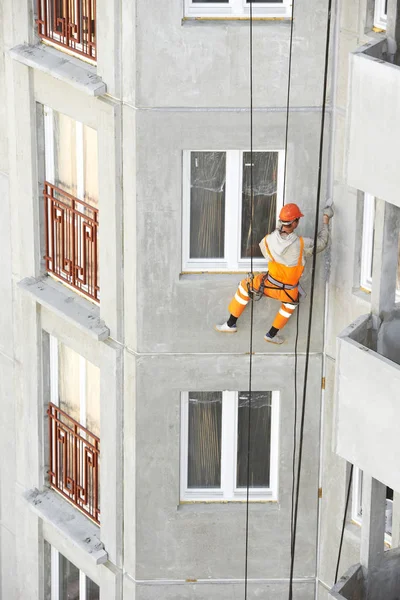 Alpinista industrial. Construtor de vedação fora fachada construção juntas de costura com mastique de isolamento — Fotografia de Stock