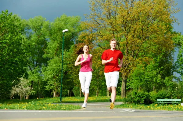 Couple jogging and running outdoors in nature — Stock Photo, Image