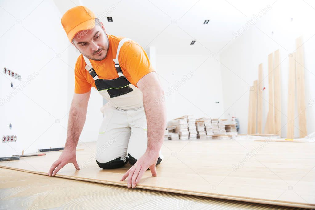 worker joining parquet floor.
