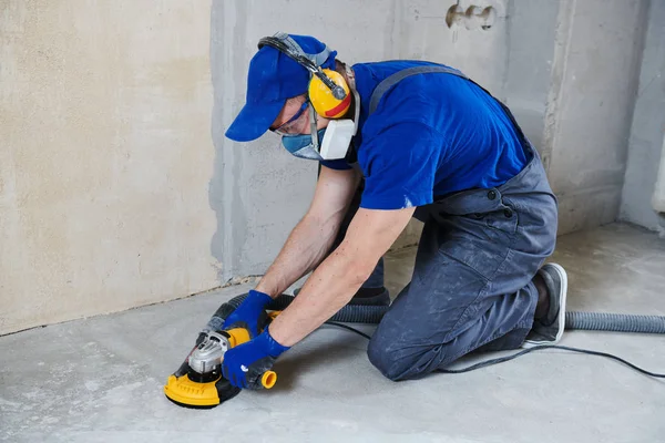 Concrete floor surface grinding by angle grinder machine — Stock Photo, Image