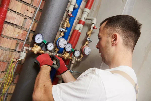 Plumber installing and mounting water equipment - meter, filter and pressure reducer — Stock Photo, Image