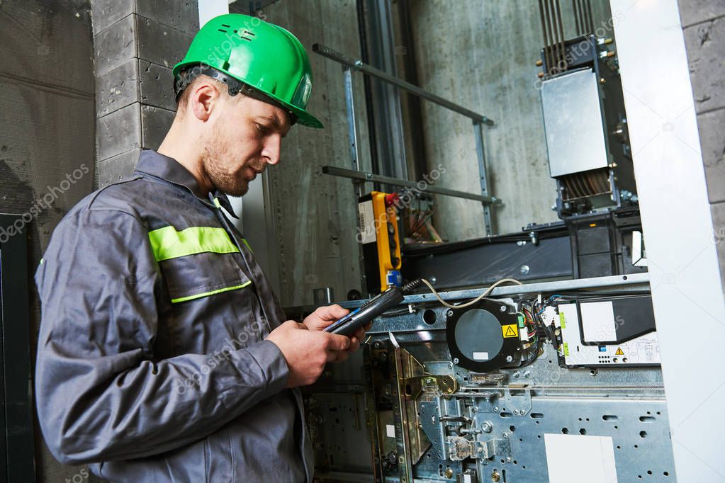 lift machinist repairing elevator in lift shaft