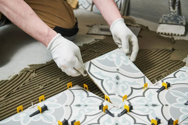 Tiler installing tile on bathroom floor. home indoors renovation — Stock Photo, Image