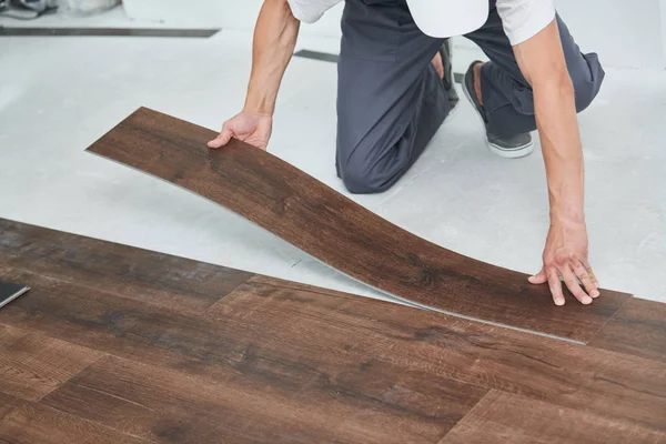 Worker joining vinyl floor covering at home renovation — Stock Photo, Image