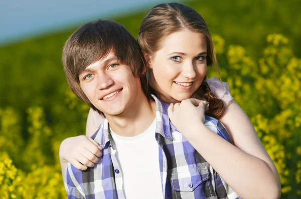 Happy young couple outdoors in field. Relationships — Stock Photo, Image