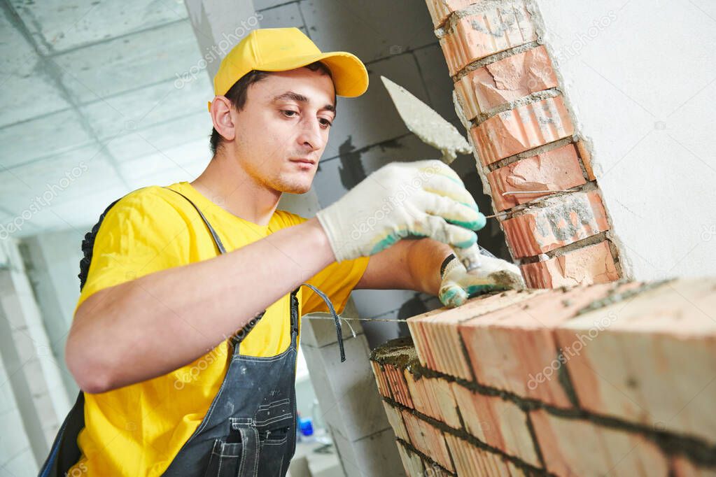 bricklayer builder worker laying bricks wall