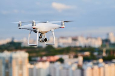 Şehir caddesinde uçan dijital kameralı insansız hava aracı