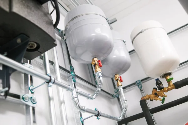 Plumbing service. stainless steel pipeline and expansion vessel of a heating system in boiler room — Stock Photo, Image