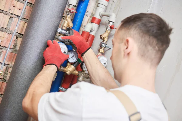 Plumber installing water equipment - meter, filter and pressure reducer — Stock Photo, Image