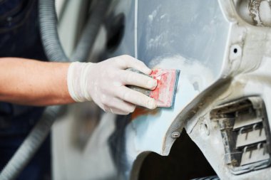 auto repairman plastering and sanding autobody bonnet clipart