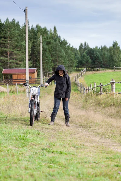 Kobieta Biały Jeździec Ubrany Kaptur Trzymający Motocykl Skrzyżowaniu Stojąca Wiejska — Zdjęcie stockowe