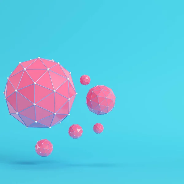 Pink low poly abstract spheres on bright blue background in past