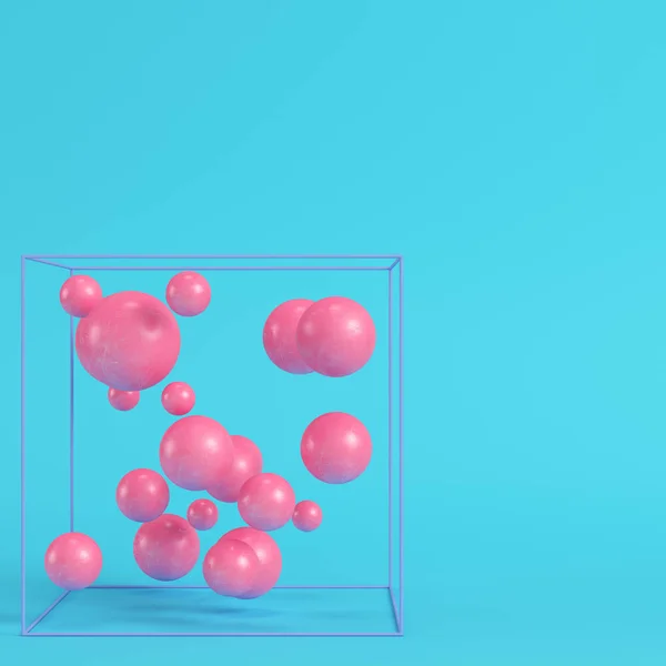 Abstract spheres in wire box on bright blue background in pastel