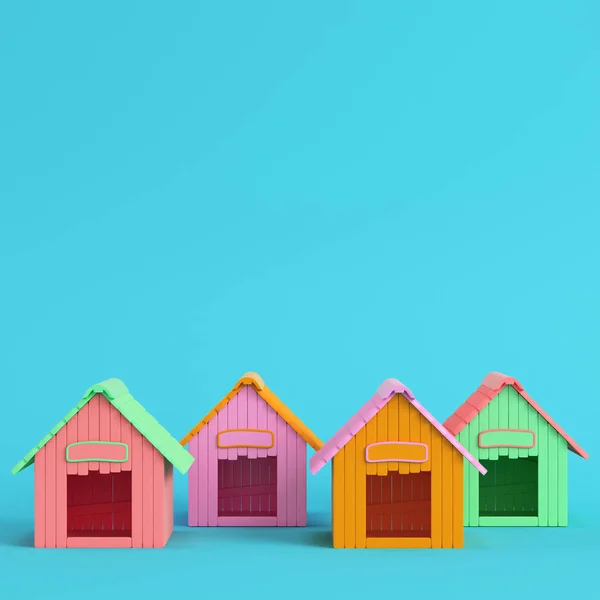 Vier kleurrijke doghouses op heldere blauwe achtergrond in pastel Colo — Stockfoto