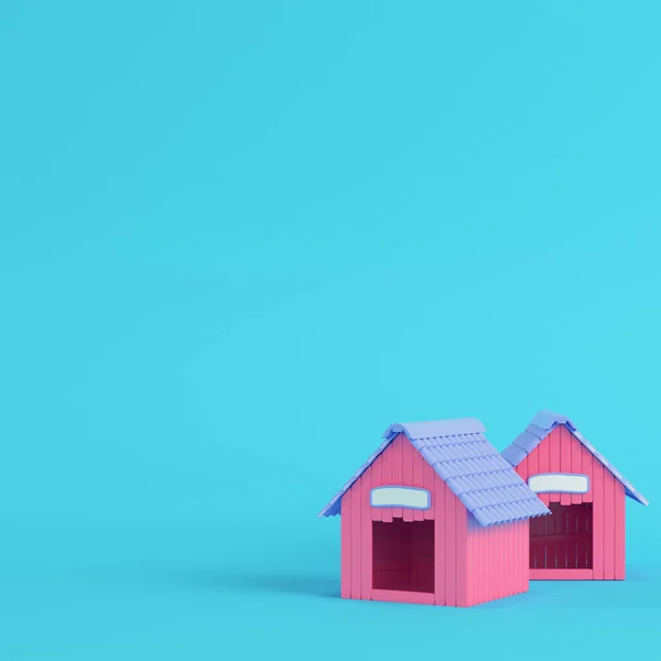 Pink doghouses on bright blue background in pastel colors — Stock Photo, Image