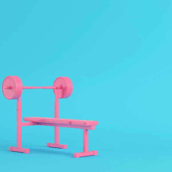 Barbell rosa com banco com bola sobre fundo azul brilhante em p — Fotografia de Stock