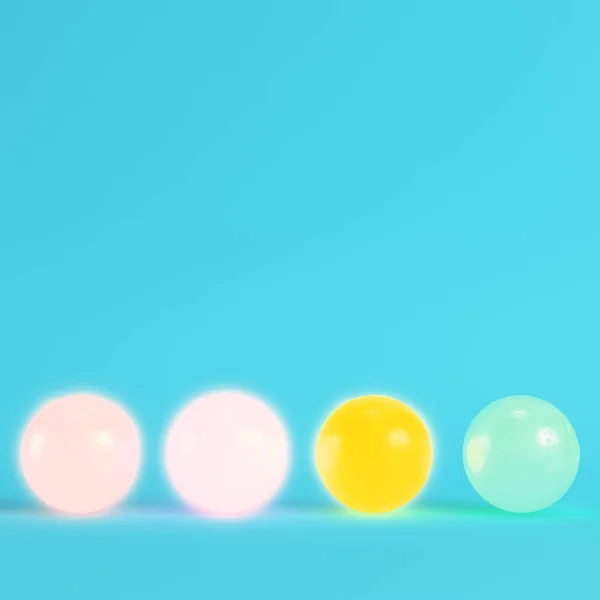 Four colorful crystal balls on bright blue background in pastel — Stock Photo, Image