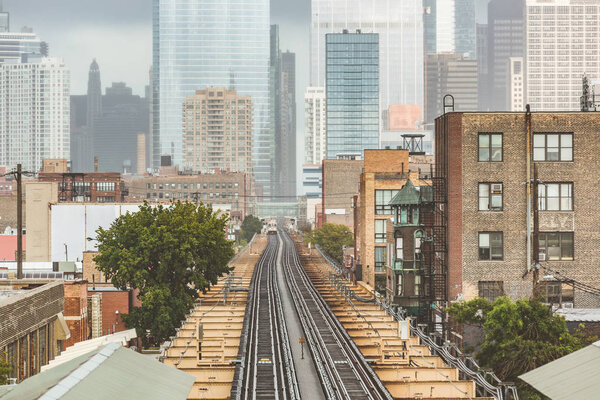 Chicago, railway view with city skyscrapers on background. Aerial view of subway tracks with financial downtown on background. Travel, architecture and transport concepts