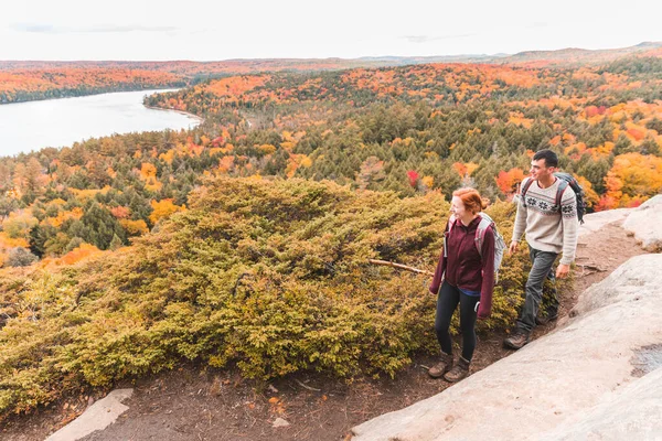 Pareja de senderismo, escena de otoño, árboles de colores en el fondo — Foto de Stock