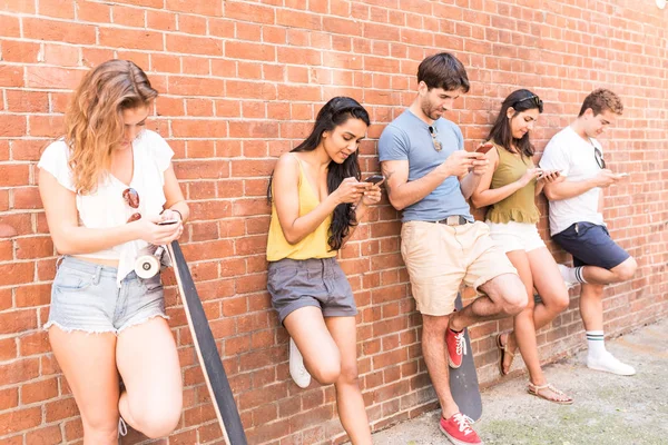 Group of friends using smartphone not interested in each other