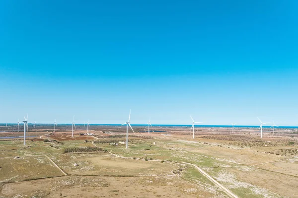 Wind turbines for electrical energy generation - Power station for clean energy production from wind in Italian countryside - Aerial view of a wind farm in Italy