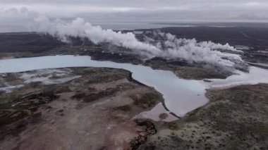 Aerial view of Gunnuhver hot springs in Iceland with steam coming out from the earth and flowing over the ground - Drone view of geothermal power plant, nature and industry concepts in Iceland