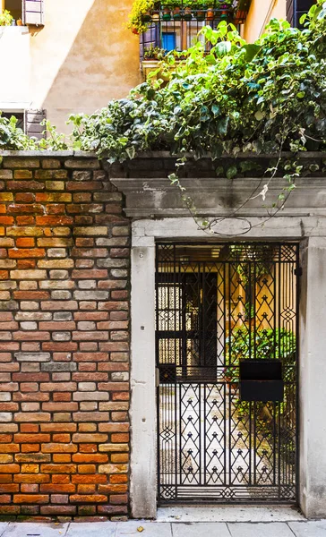 Openwork gate of old house in Venice. Entrance to the home in the medieval italian town.