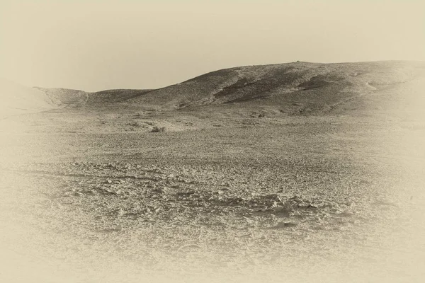 Desolate infinity of the Rocky hills of the Negev Desert in Israel. Breathtaking landscape and nature of the Middle East. Black and white photo