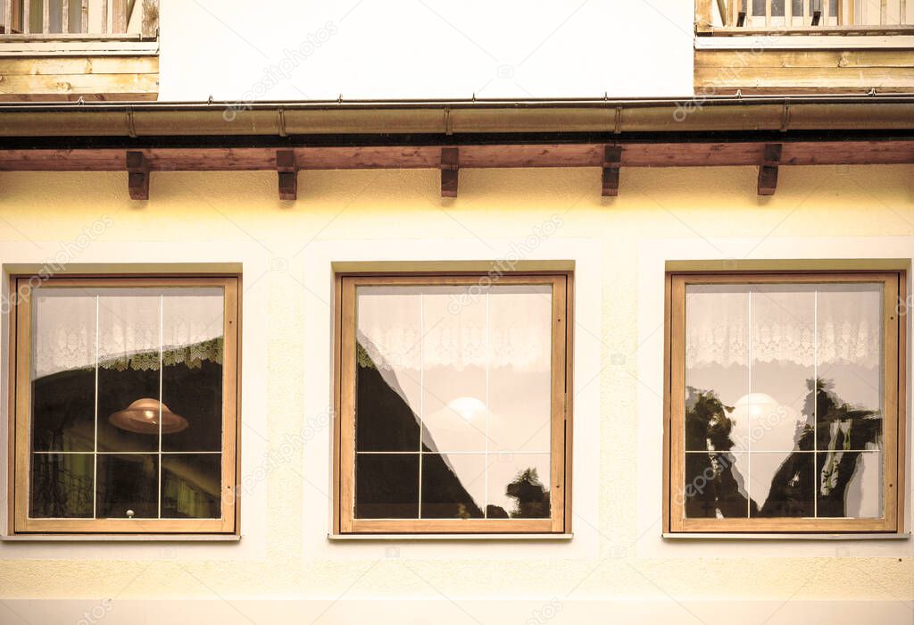 Typical window of a house in a small town in Austria. Home in the Austrian city of St Wolfgang in a rainy day. Retro style