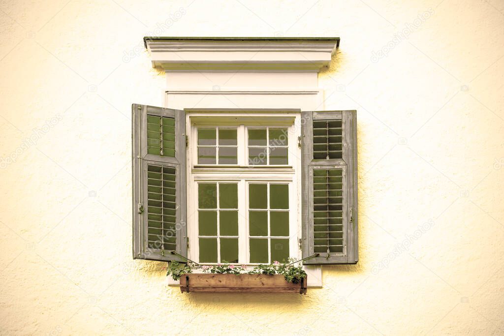 Typical window of a house in a small town in Austria. Home in the Austrian city of St Wolfgang in a rainy day. Retro style