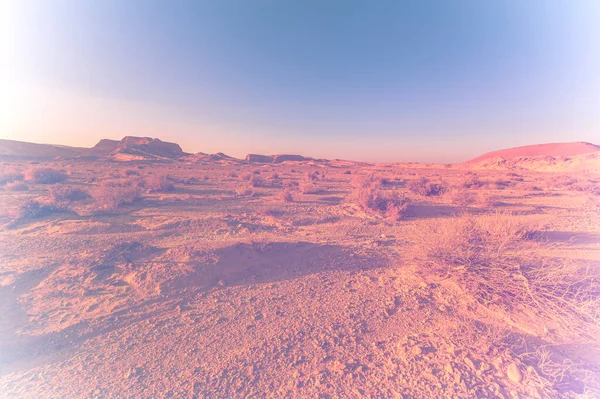 Breathtaking landscape of the rock formations in the Israel desert in faded color effect. Lifeless and desolate scene as a concept of loneliness, hopelessness and depression.