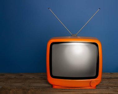 Boş ekran ve koyu arkaplanda anten olan eski, parlak, klasik bir televizyon.