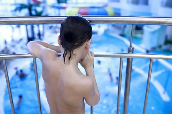 Boy looks at pool in water park