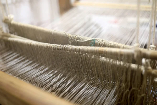 Details of vintage textile loom with wool threads